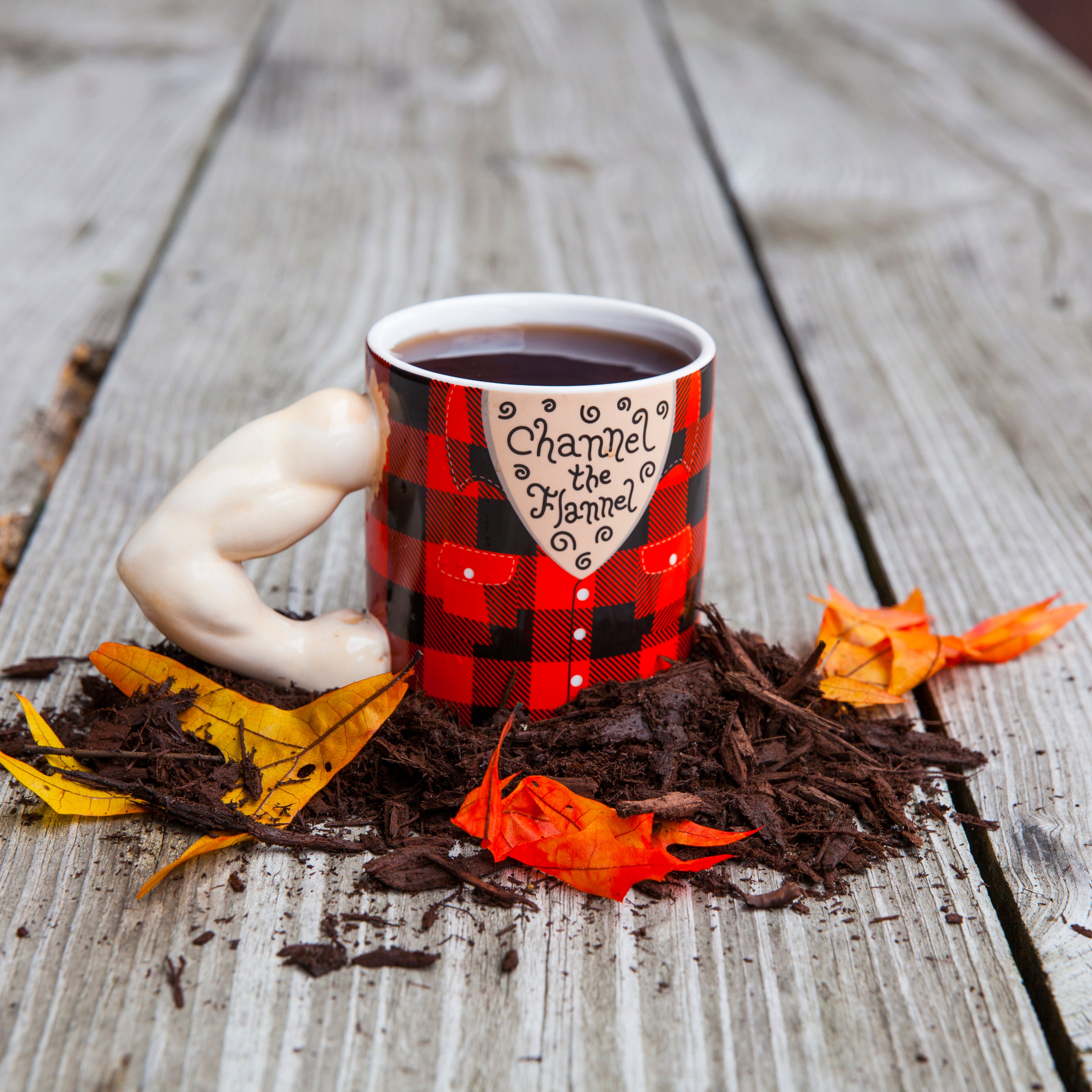 Channel the flannel mug for coffee or tea. The mug handle looks like an arm with big muscles and the cup part of the mug is depicting a torso wearing a flannel shirt.